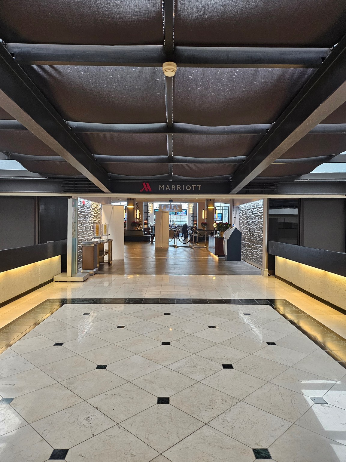 a hallway with a black and white tiled floor