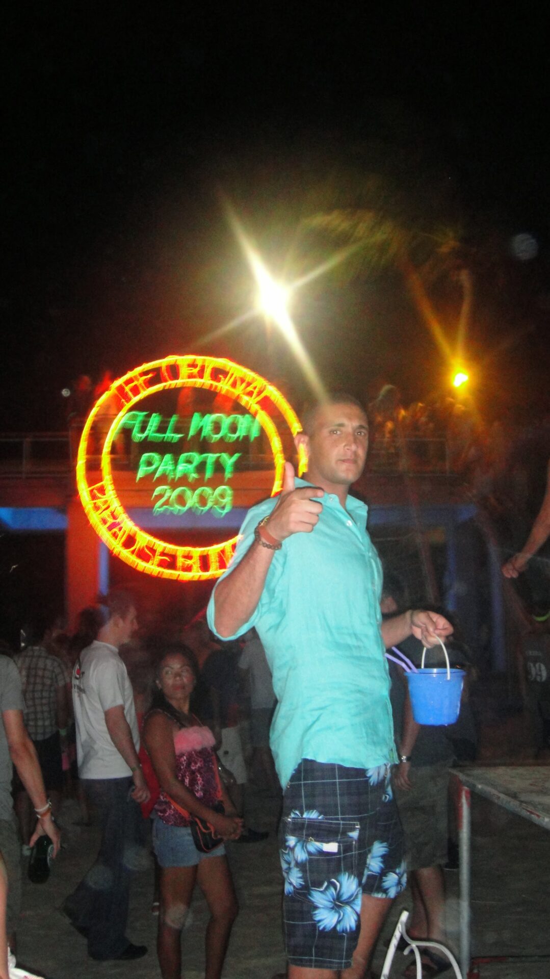 a man holding a bucket and a sign