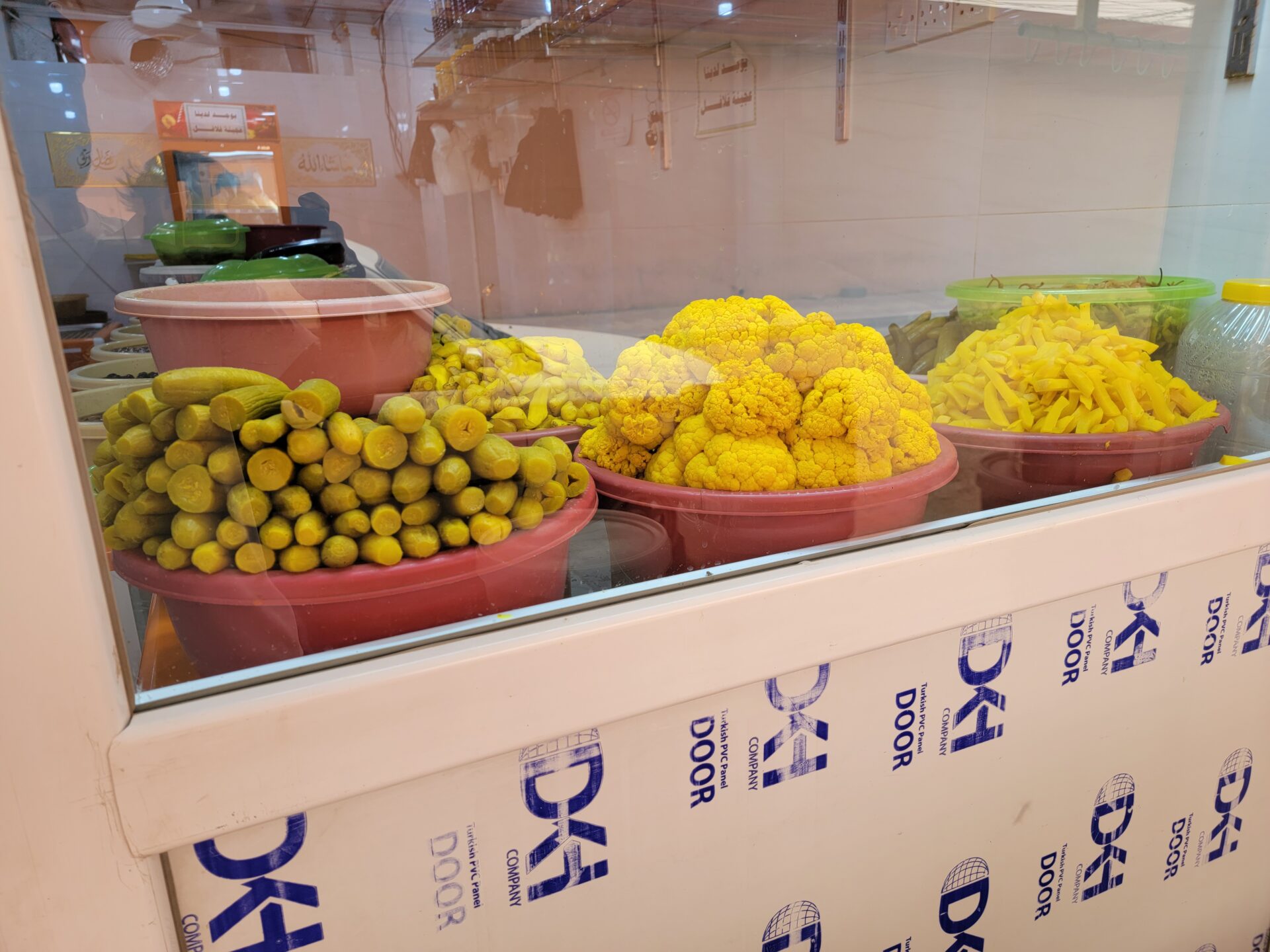 a group of bowls of vegetables in a display case