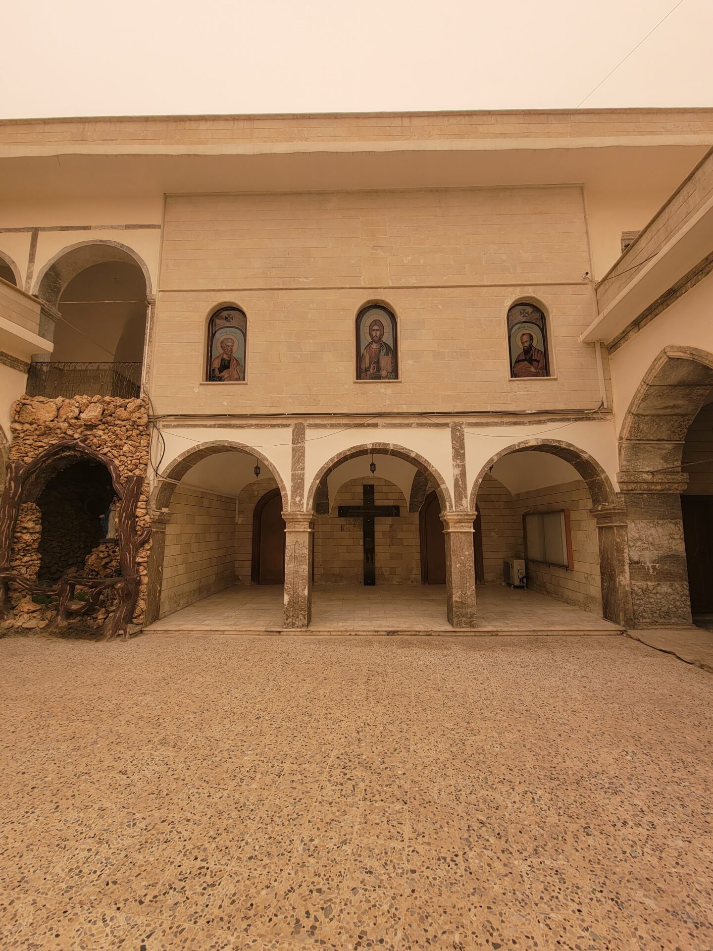 a building with arches and a cross