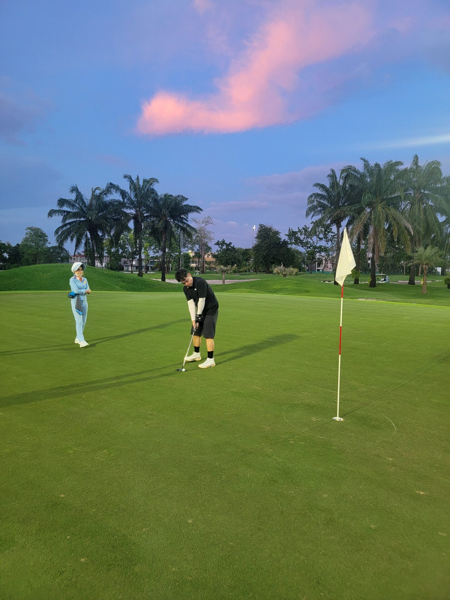 a man and woman on a golf course