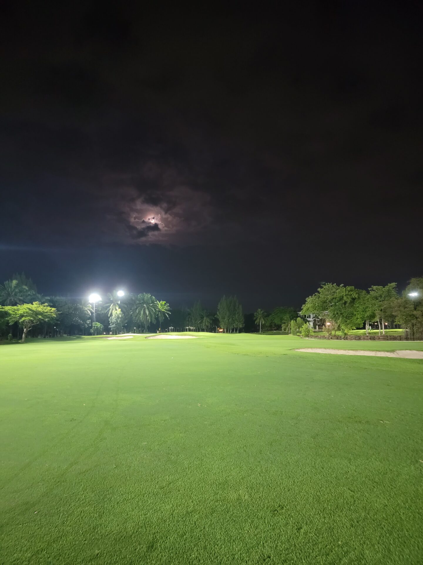 a large green field at night