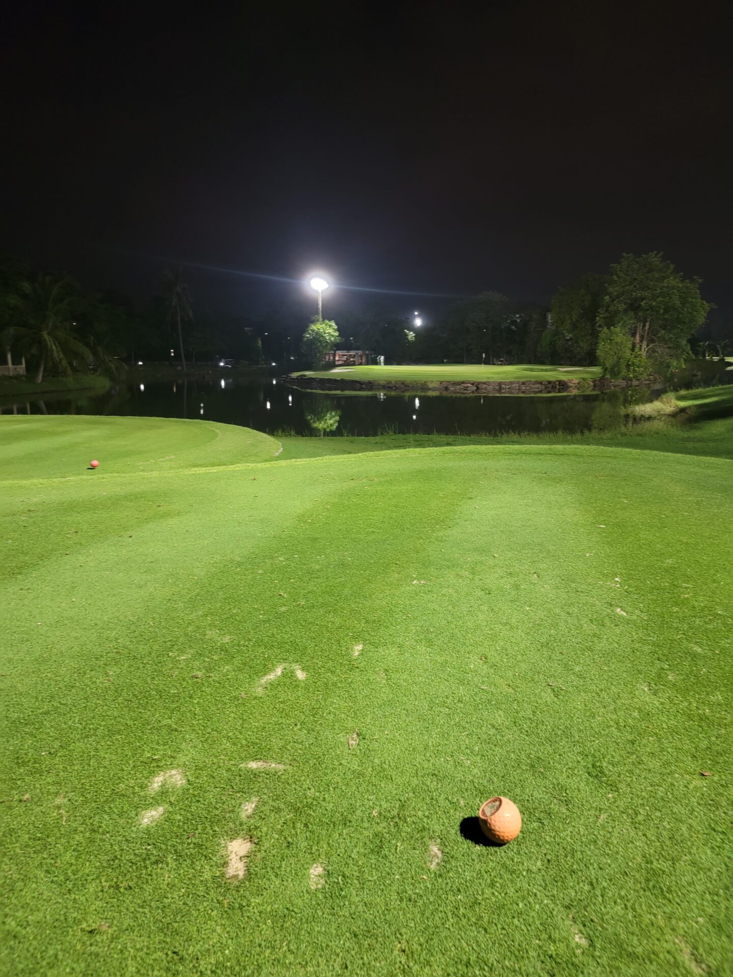 a golf course with a ball on the ground