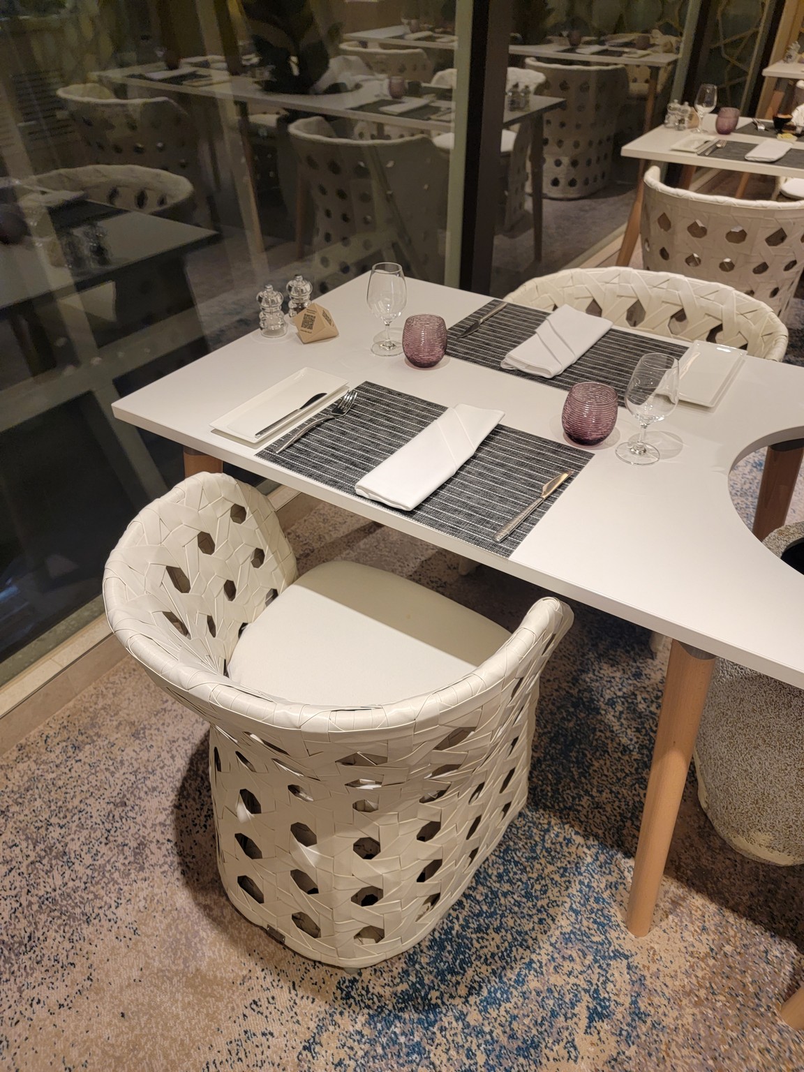 a table with chairs and glasses