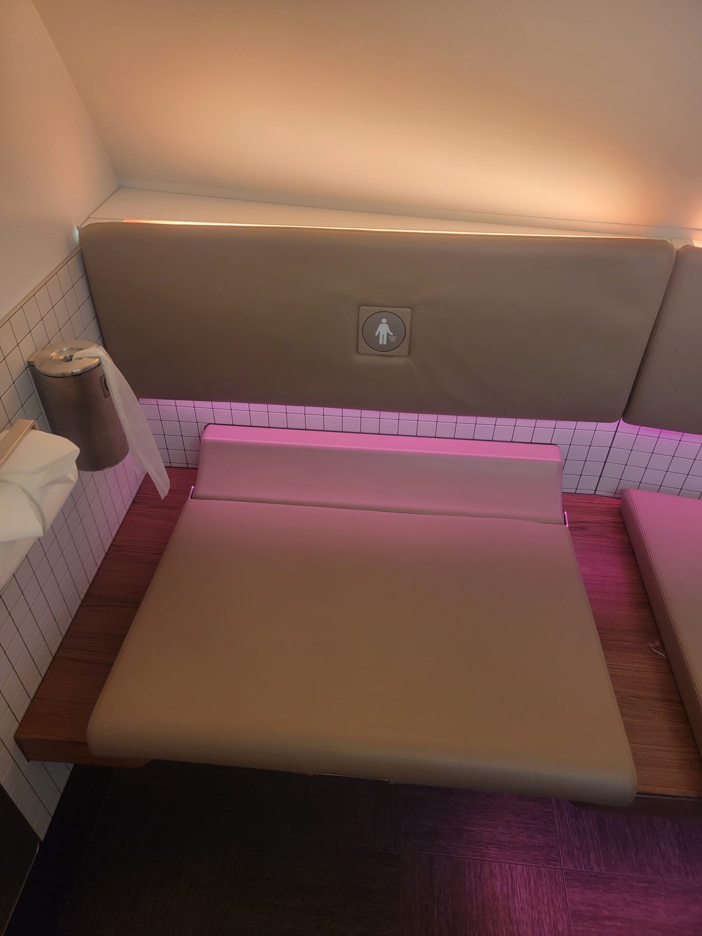 a seat with pink lights