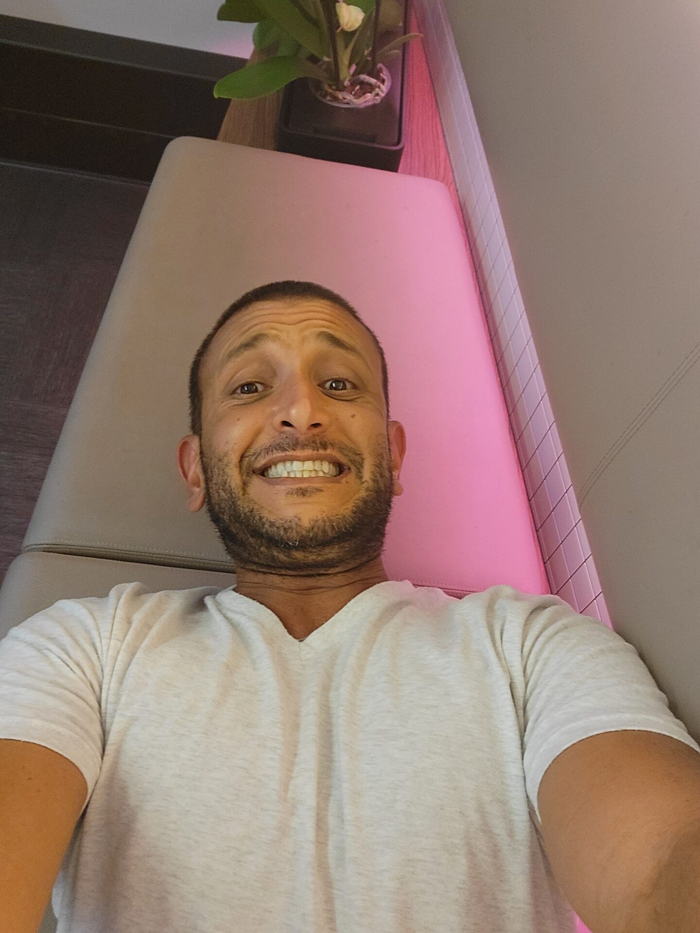 a man lying on a couch smiling