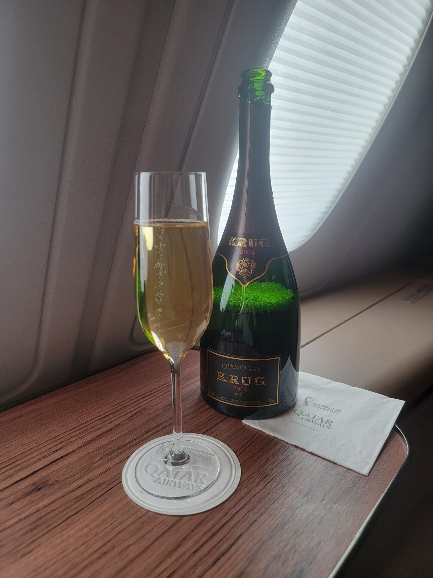 a bottle and glass of champagne on a table