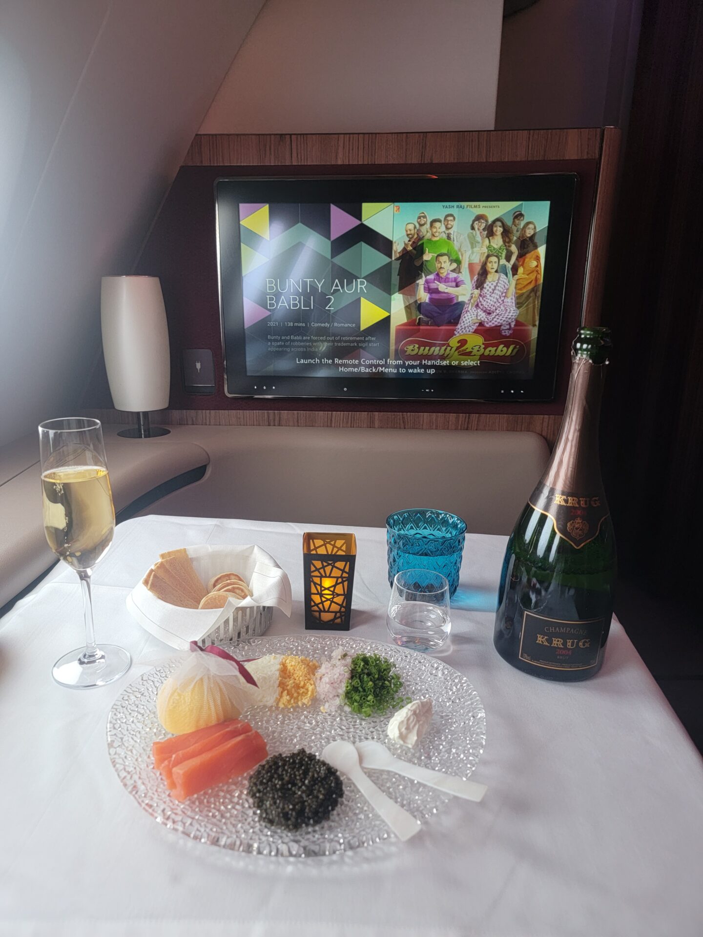 a table with food and a tv in the background