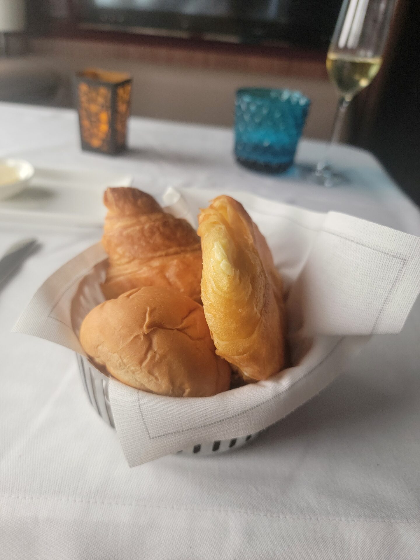 a basket of bread and rolls on a table