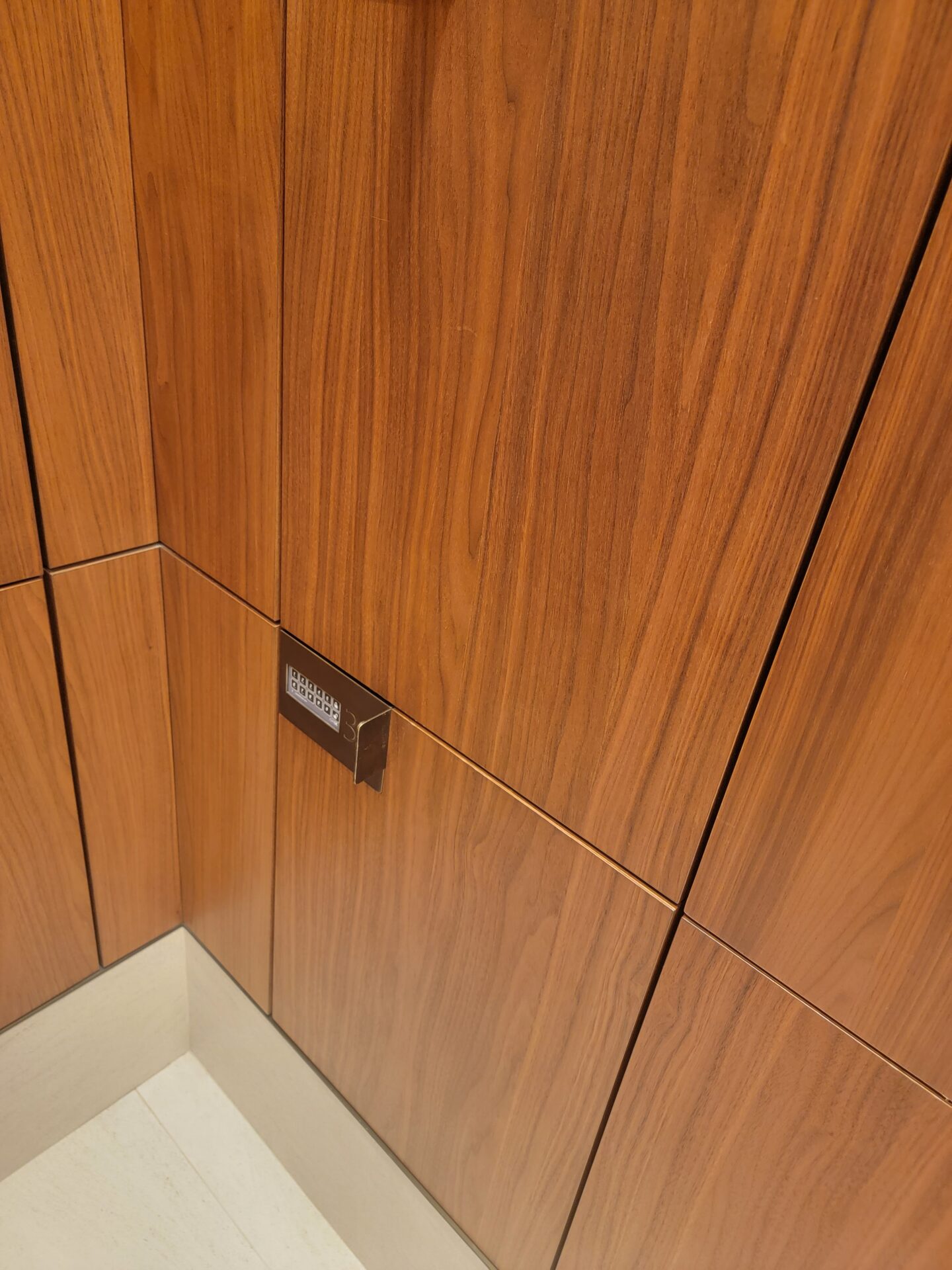 a wood paneled wall with a square outlet