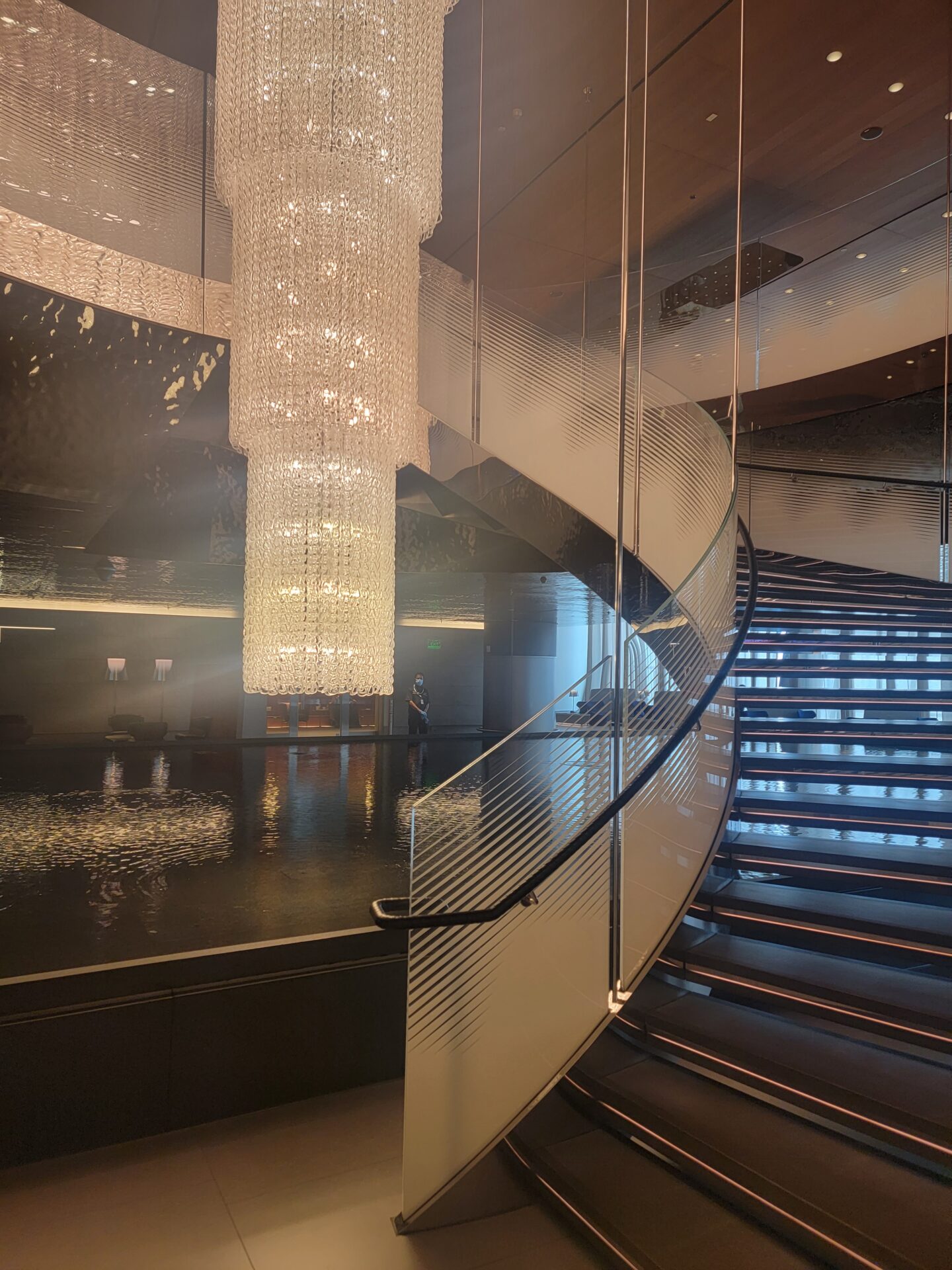 a spiral staircase with chandeliers