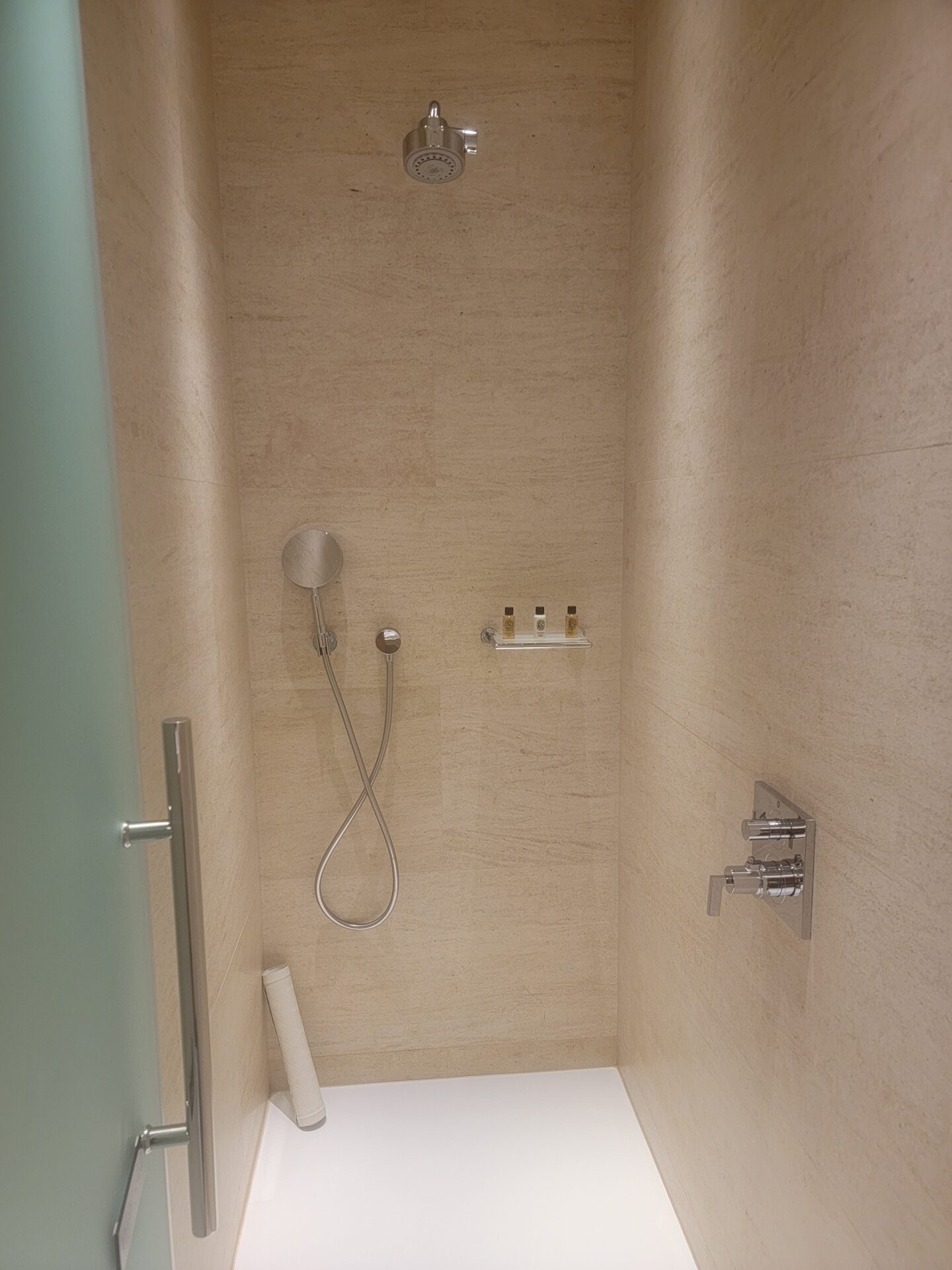 a shower with a shower head and a shower head