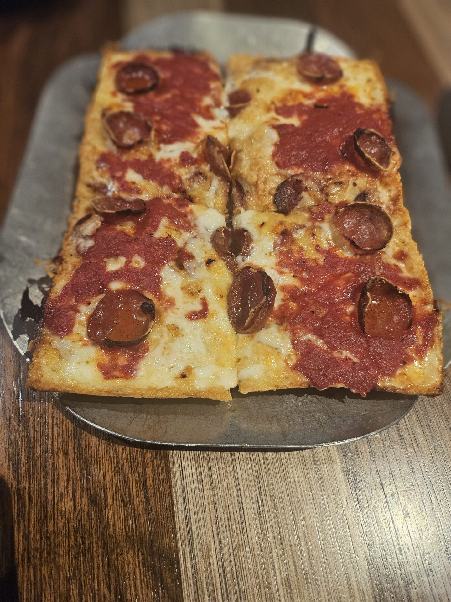 a rectangular pizza with pepperoni on top