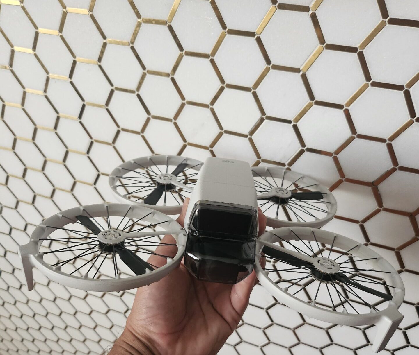 a hand holding a drone