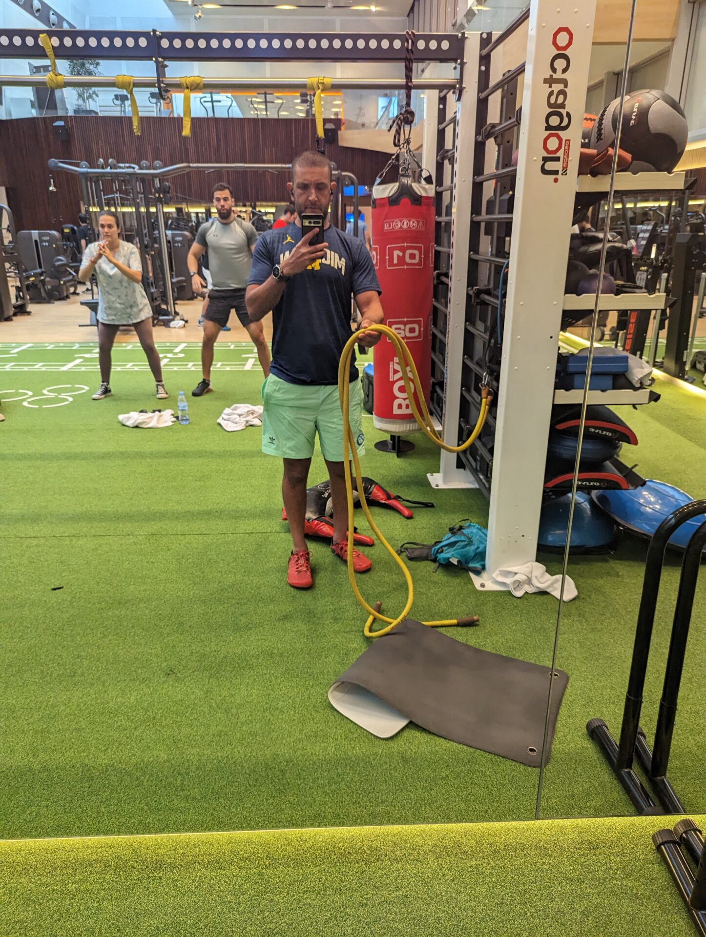 a man holding a rope in a gym