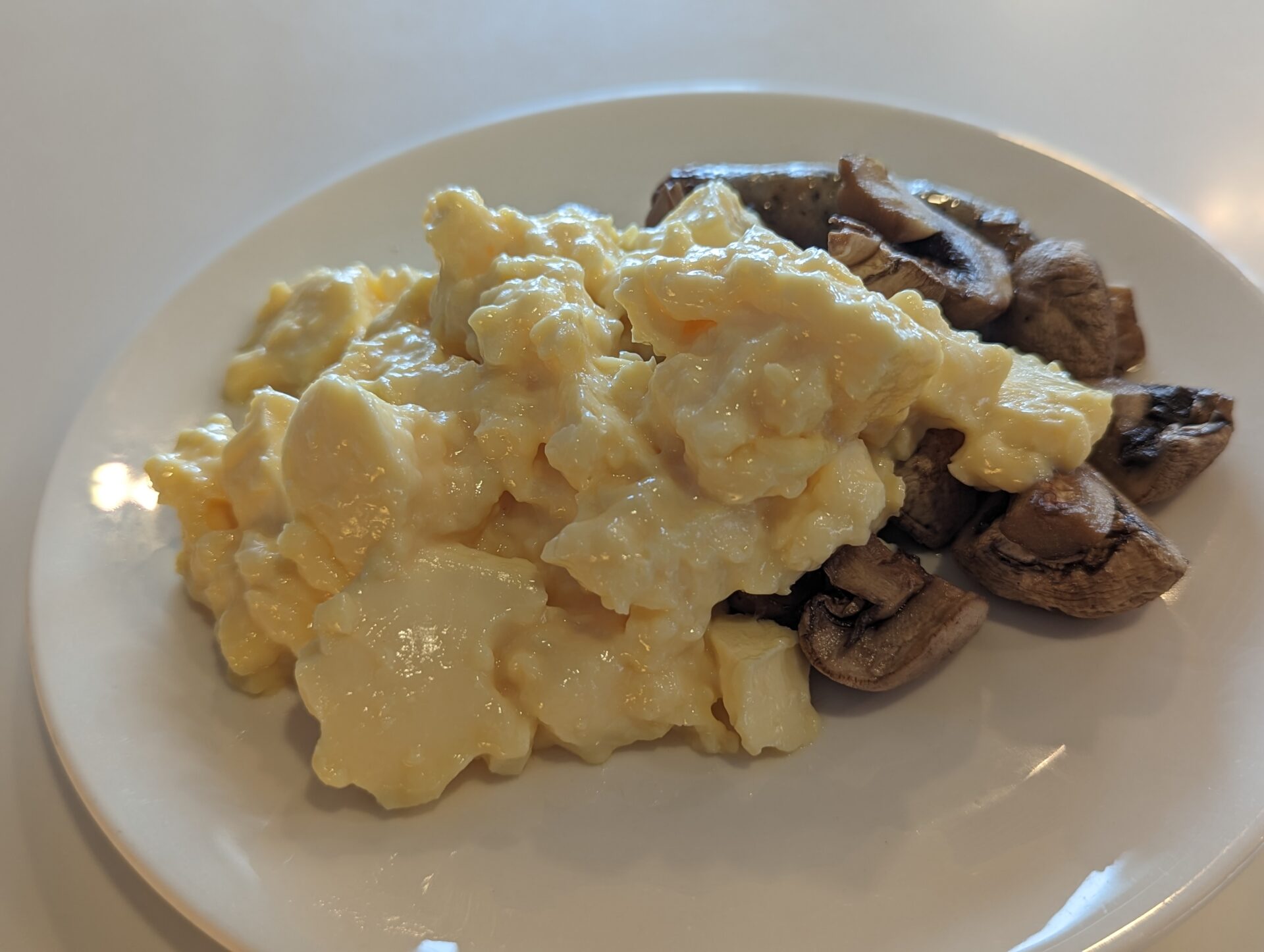 a plate of scrambled eggs and mushrooms