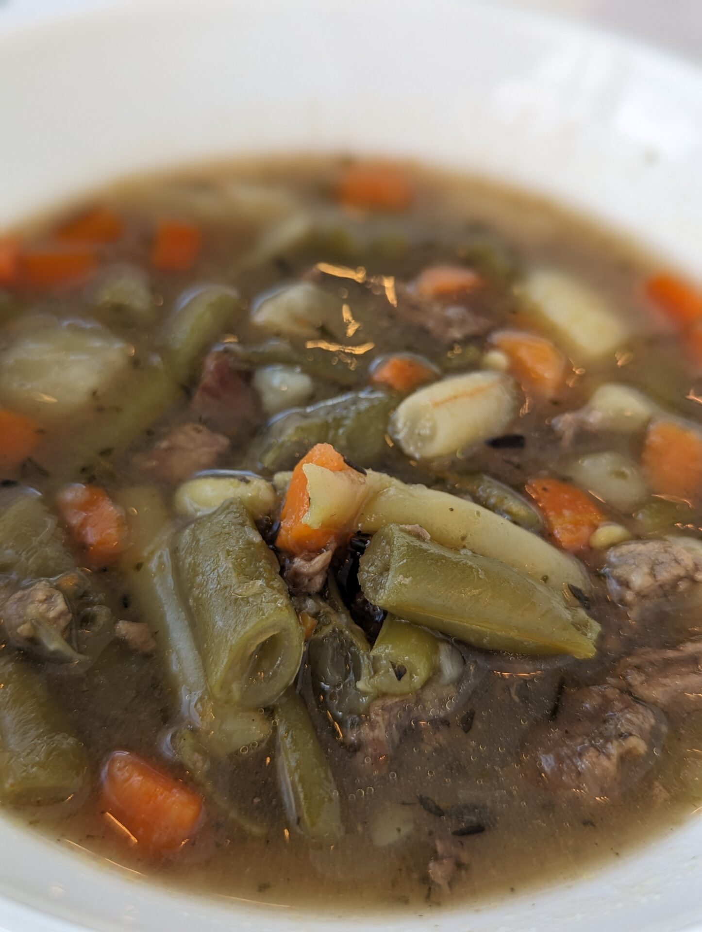 a bowl of soup with meat and vegetables