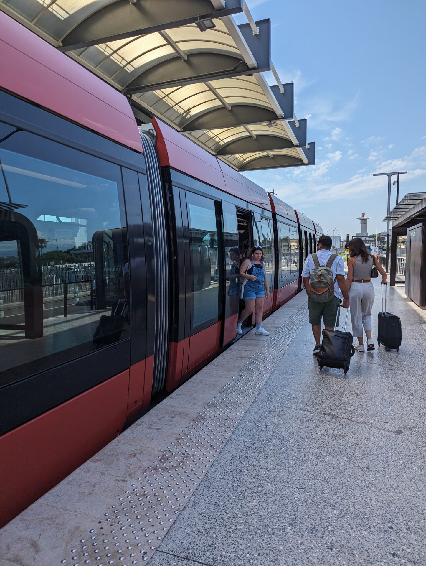 people standing next to a train