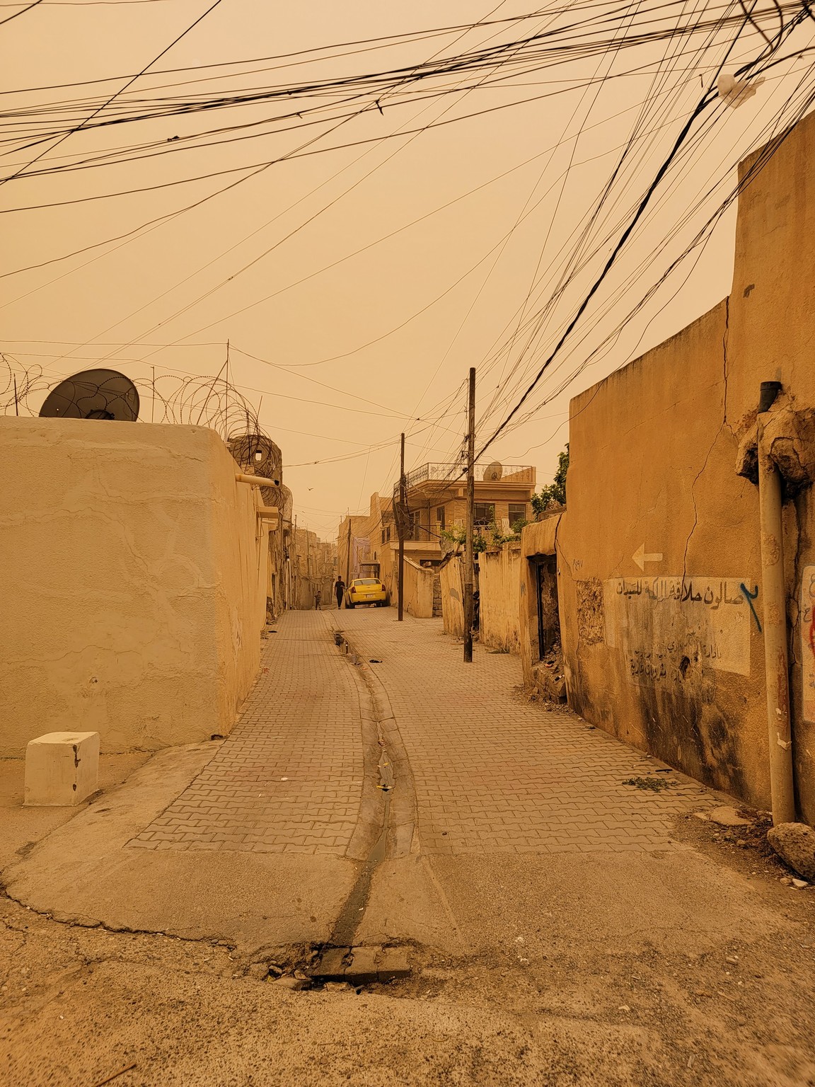 a street with buildings and power lines