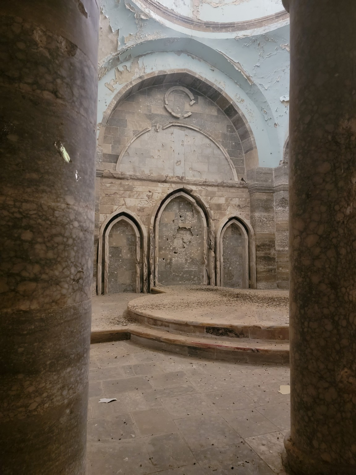 a stone room with columns and arches