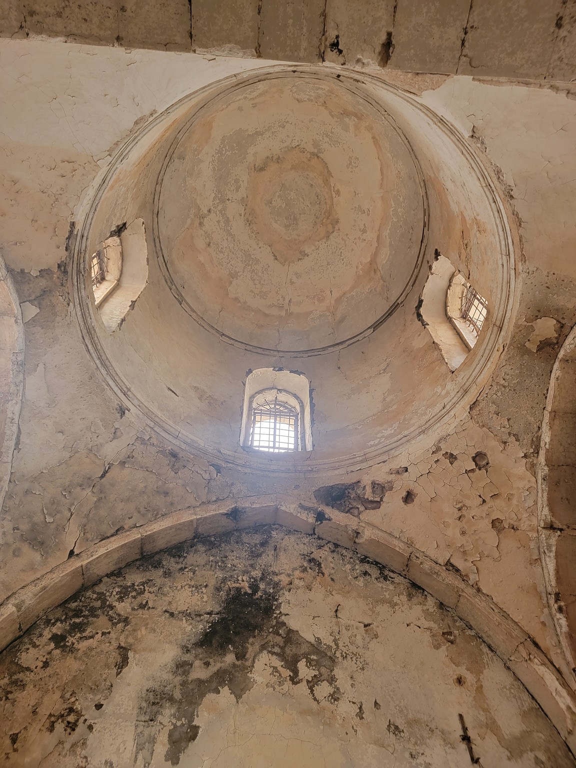 looking up at a ceiling with a window in the middle