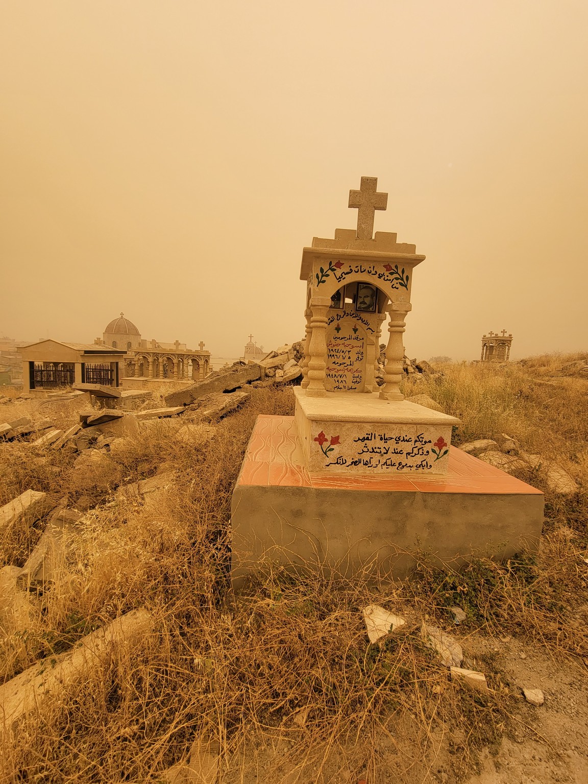 a cemetery with a cross on top of it