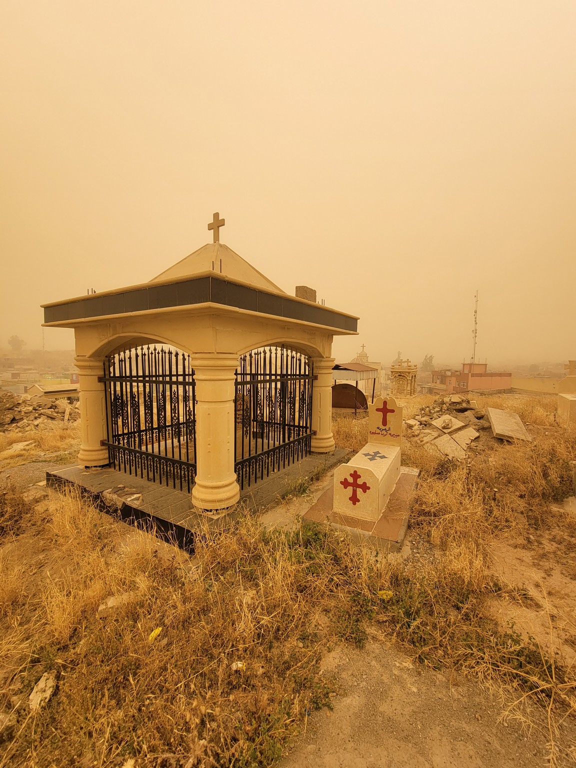 a cemetery with a cross on top