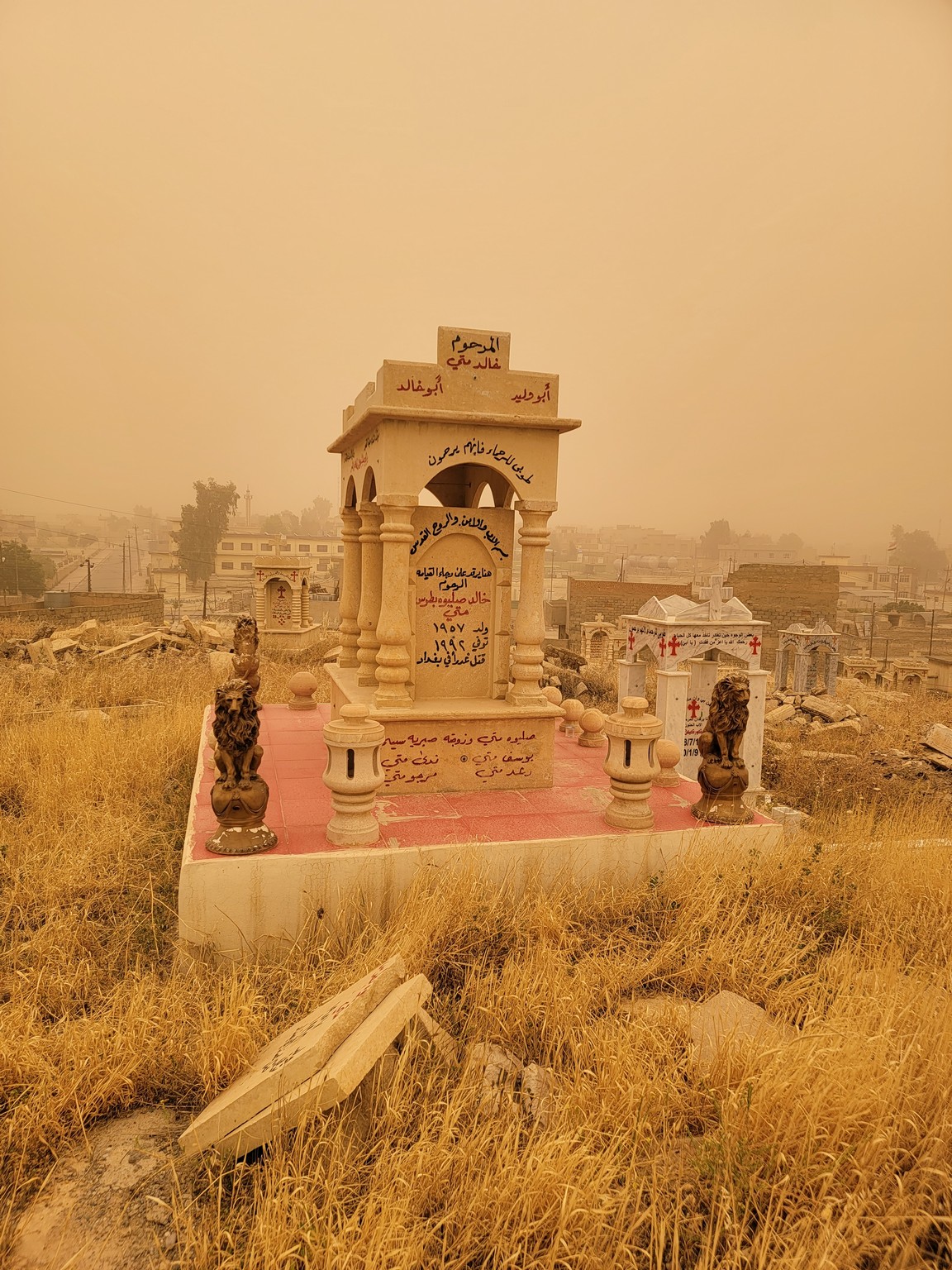 a cemetery with a city in the background