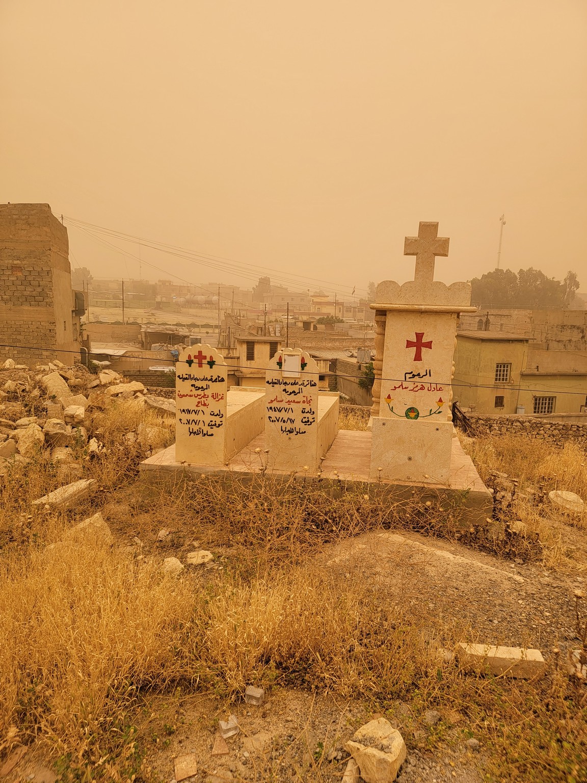 a cemetery with a city in the background