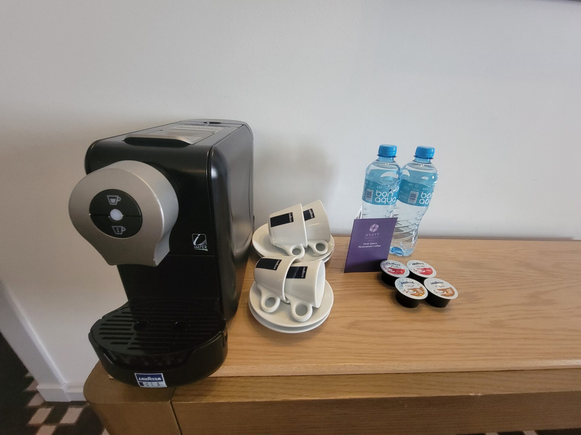 a coffee machine and cups on a table