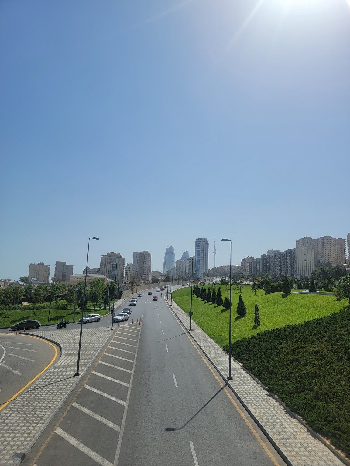 a road with cars and buildings in the background