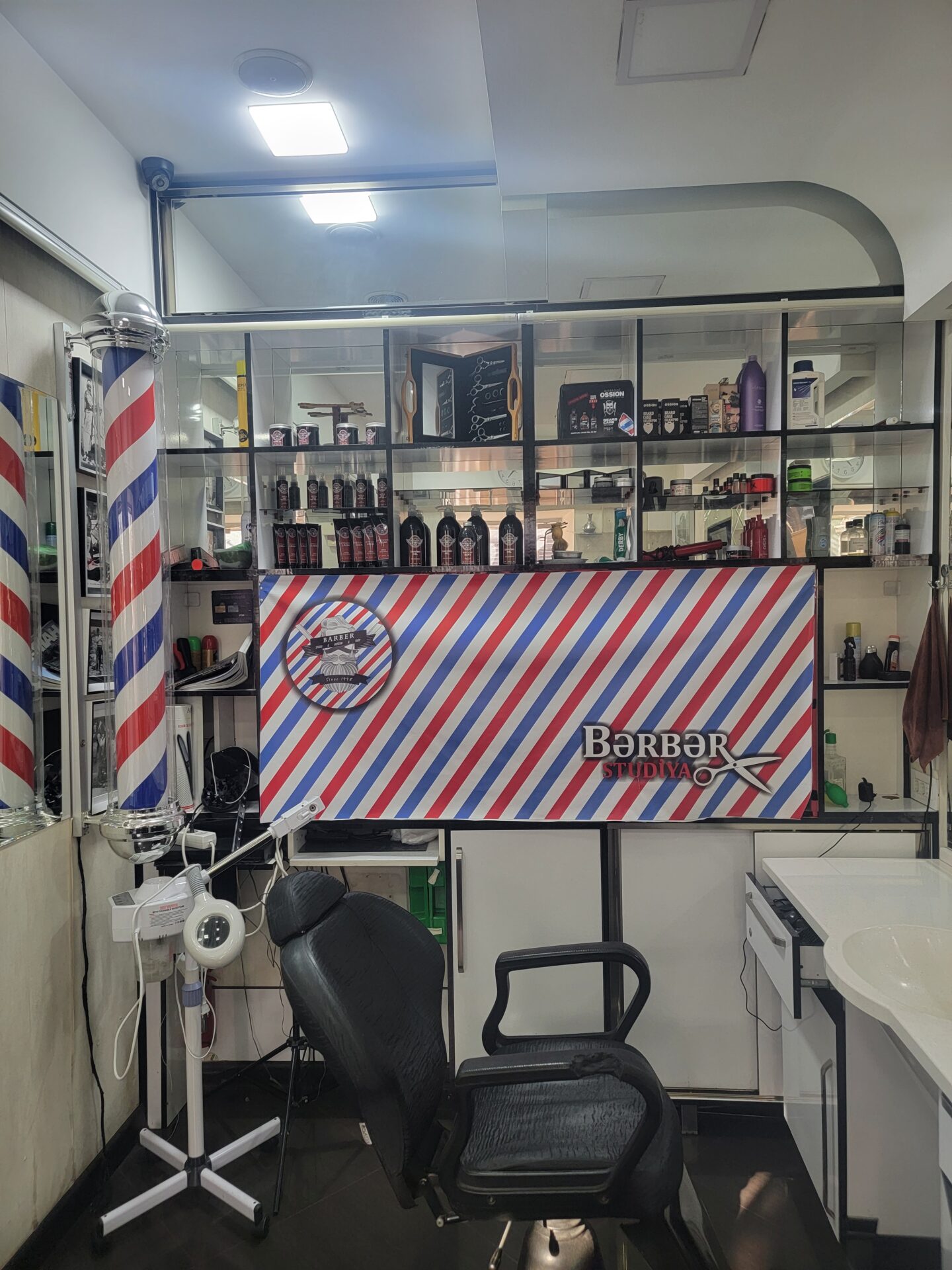 a barber shop with a chair and a sink