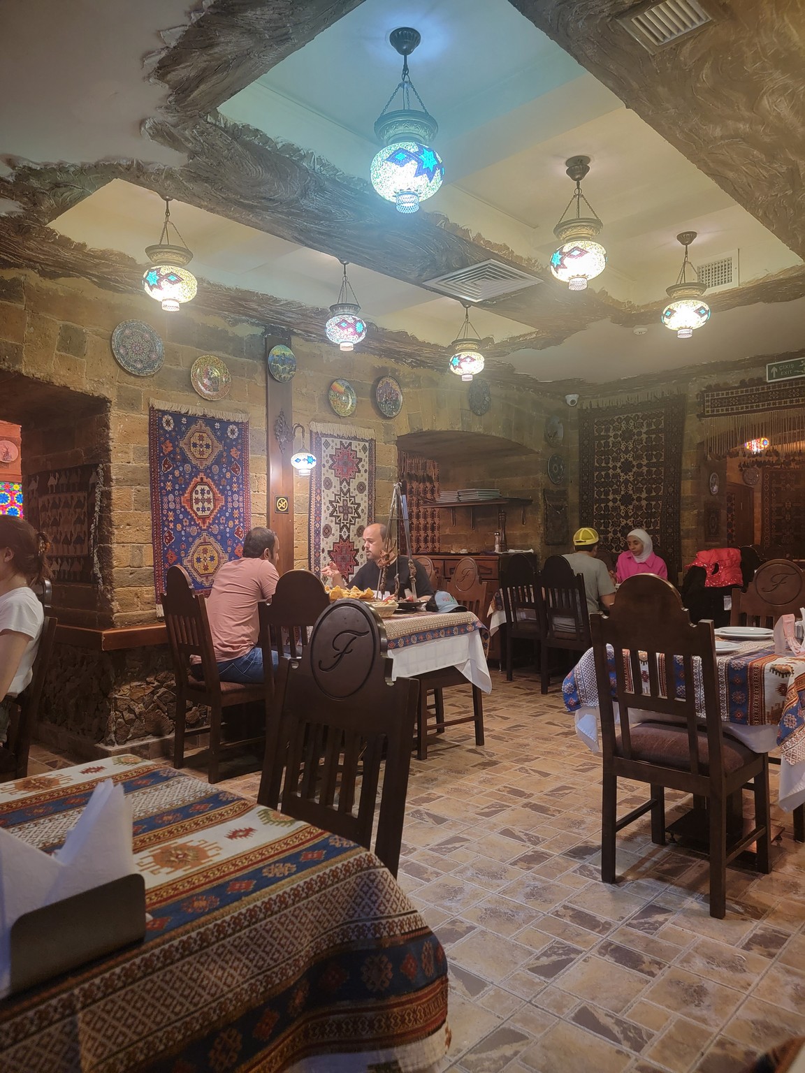 a group of people sitting at tables in a restaurant