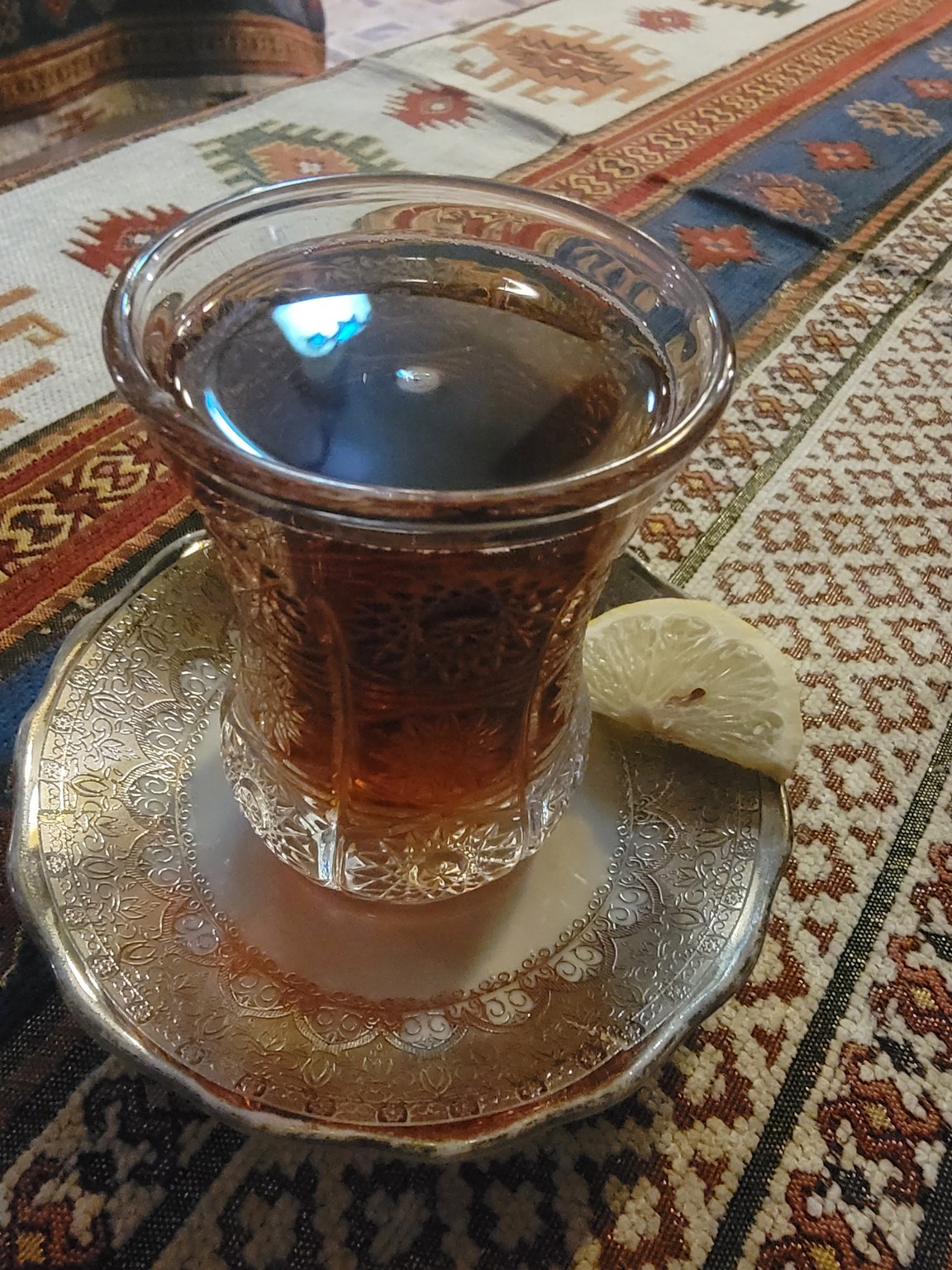 a glass of liquid on a plate