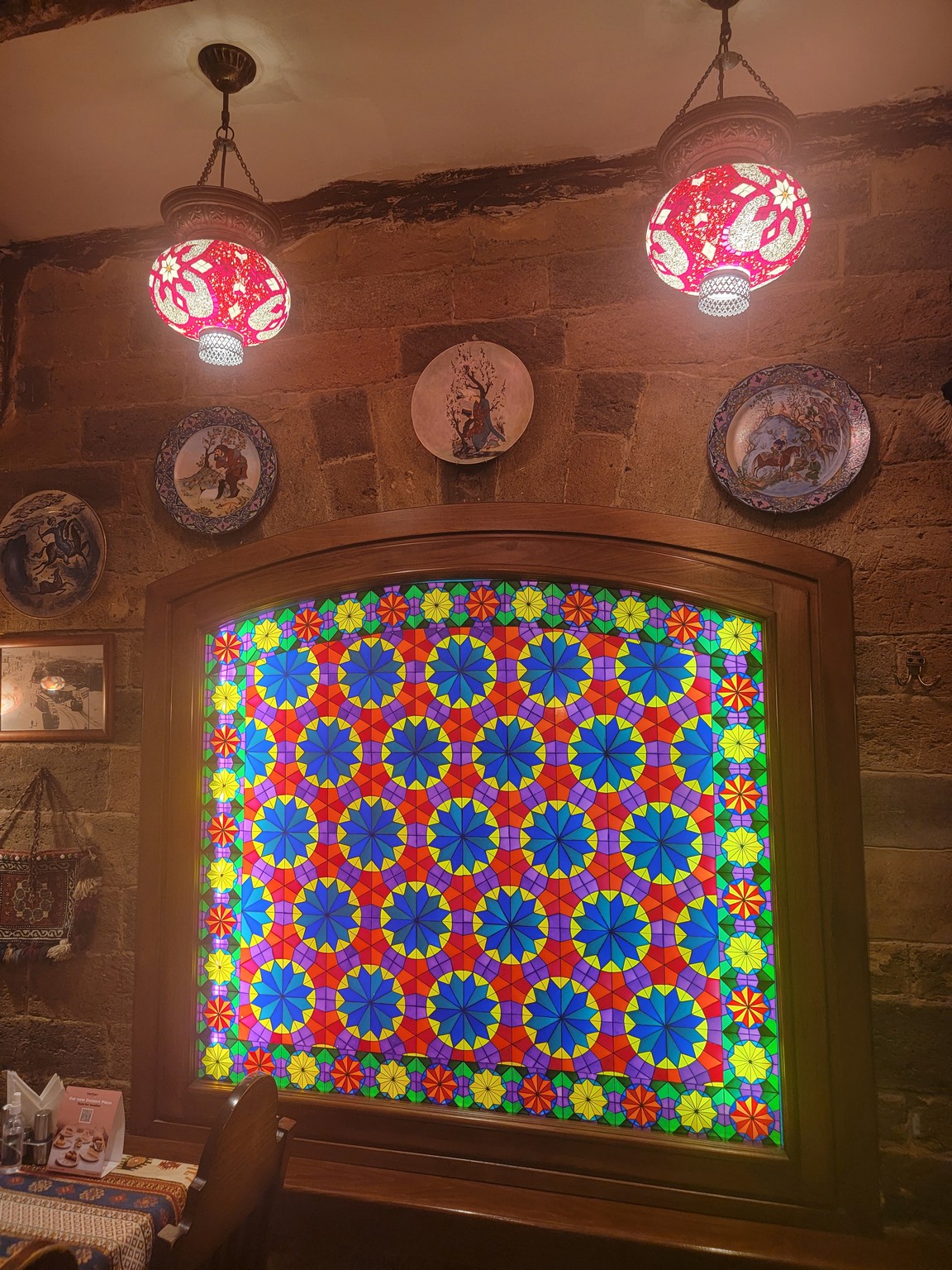 a stained glass window with colorful designs on it