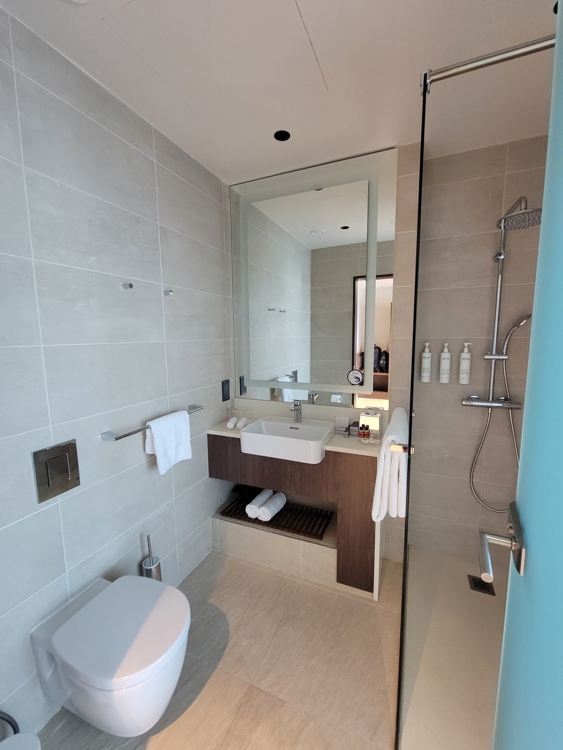 a bathroom with a glass shower door