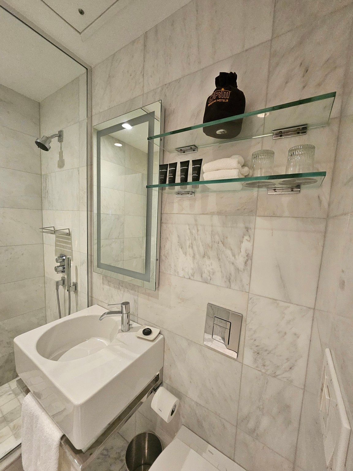 a bathroom with a mirror and shelves