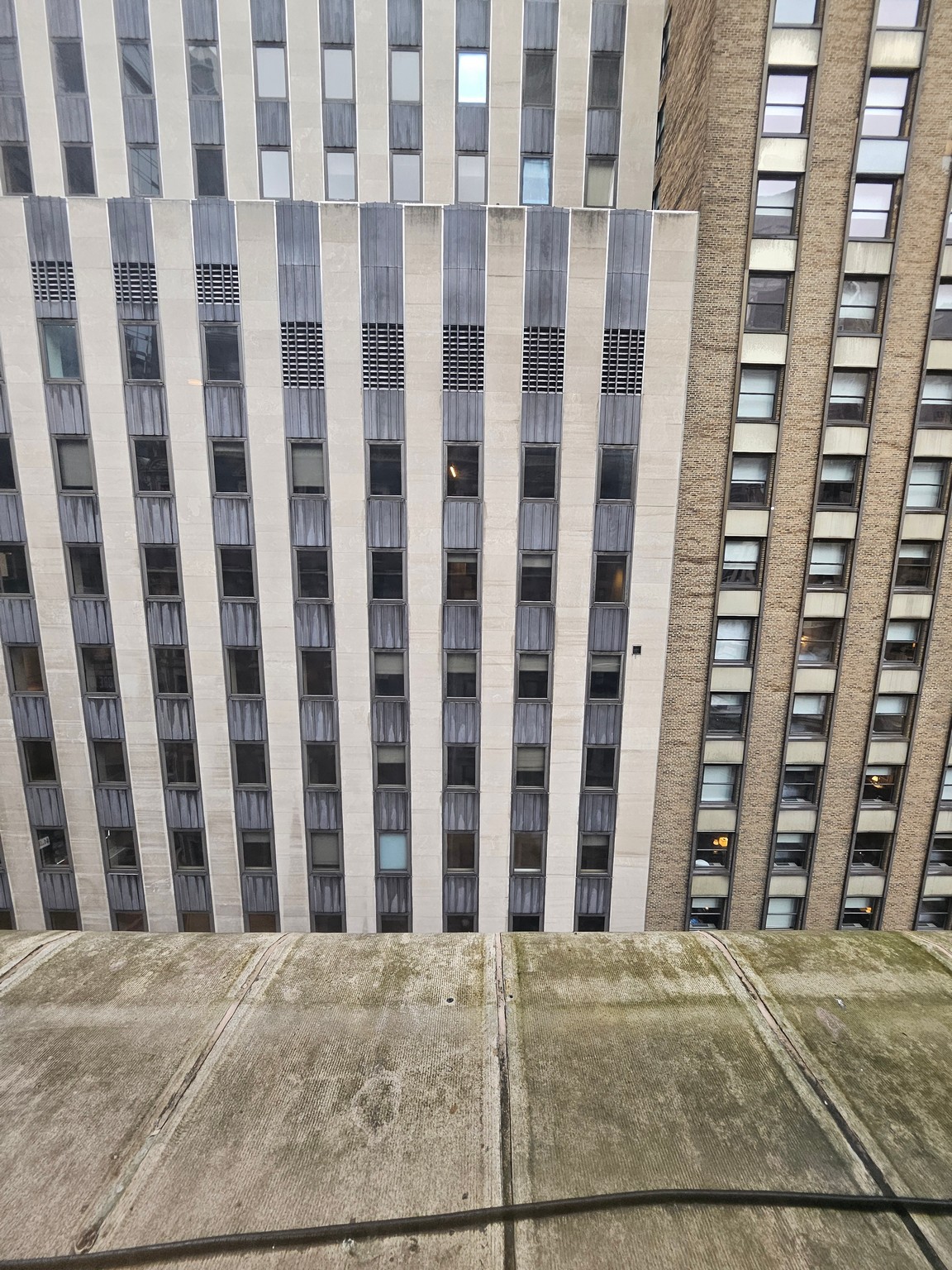 a concrete surface with windows in the background