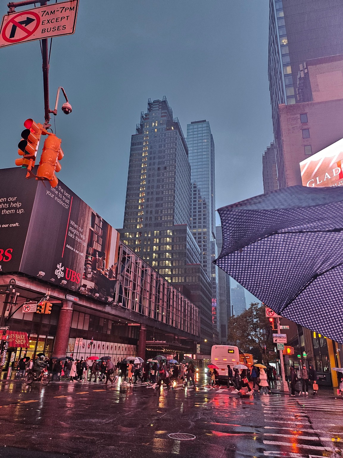 a city street with umbrellas and buildings