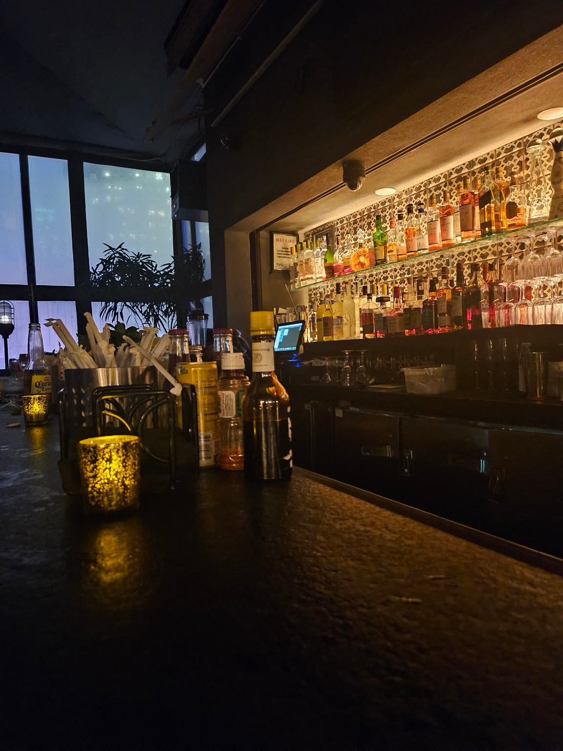 a bar with bottles and glasses on it