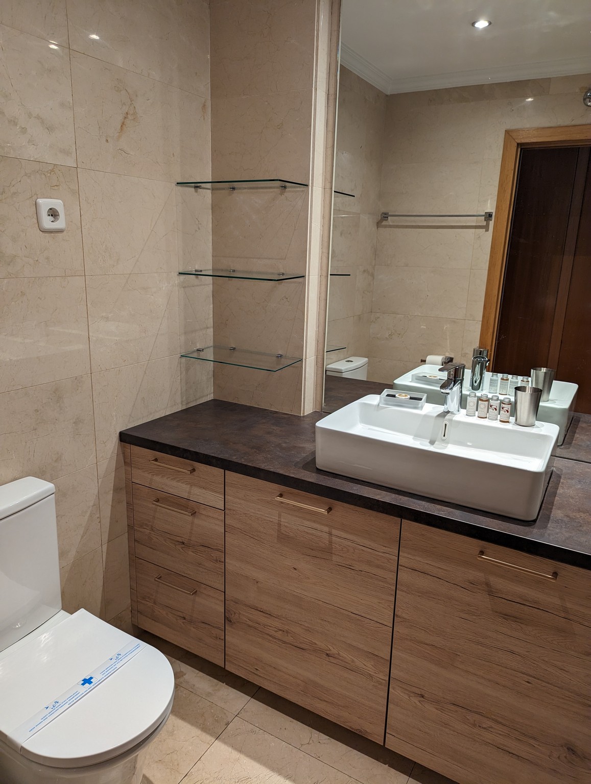 a bathroom with a sink and shelves