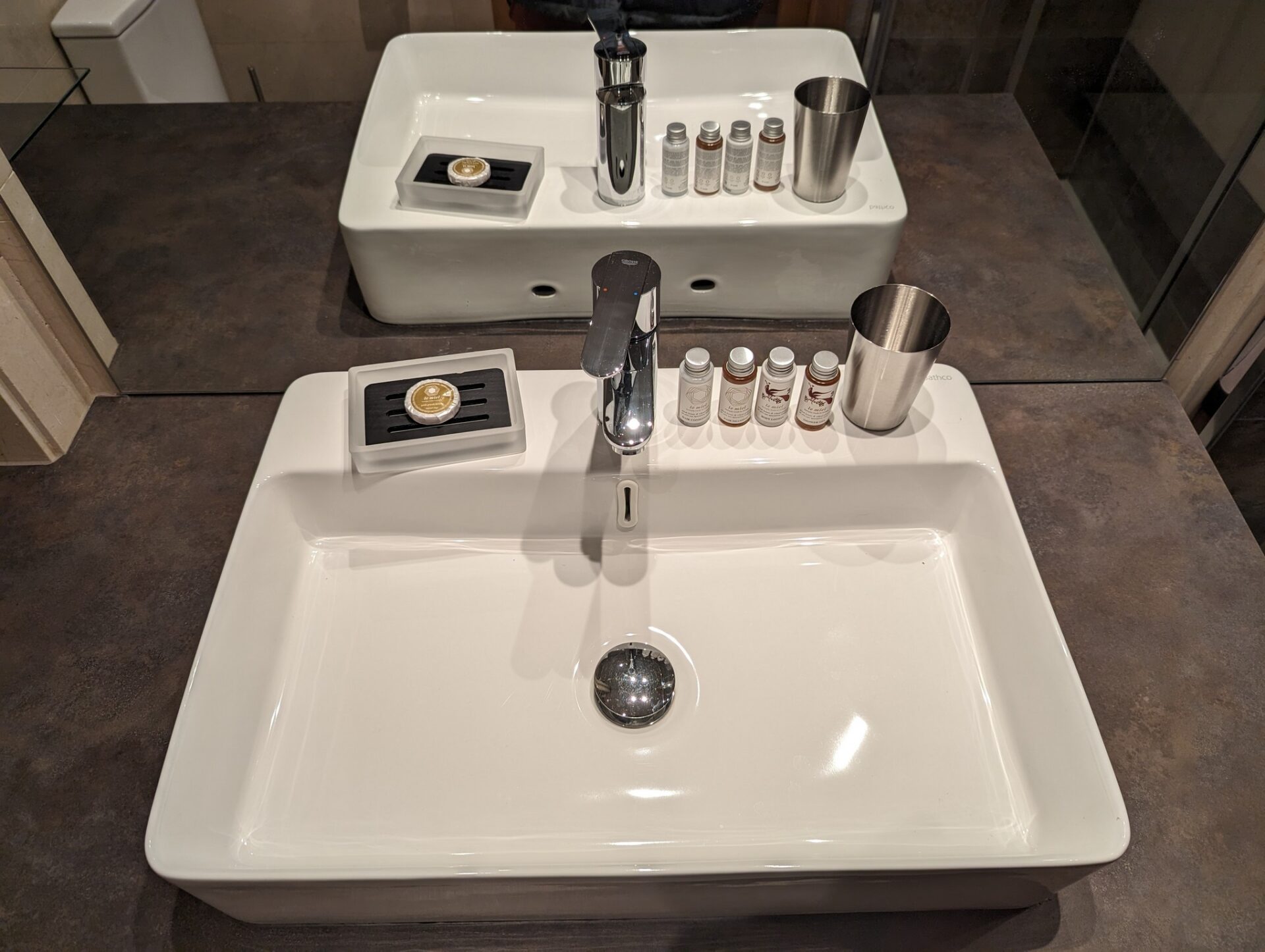 a sink with a faucet and a soap dish