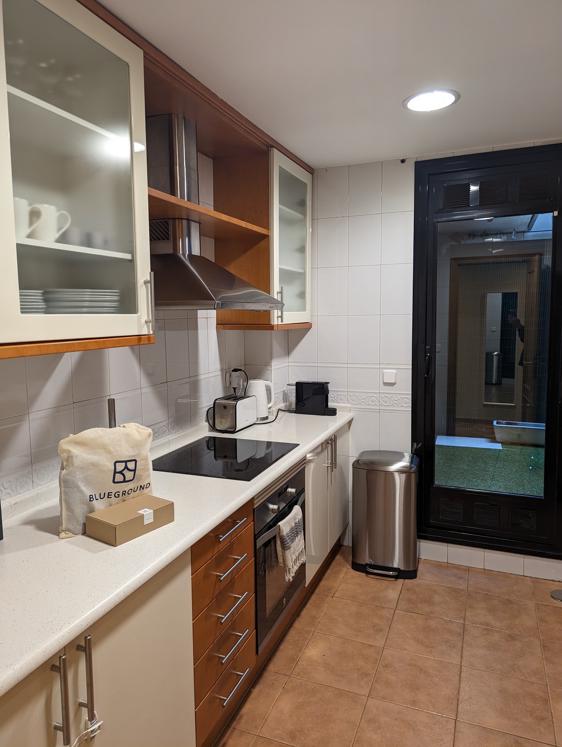 a kitchen with white cabinets and a black countertop