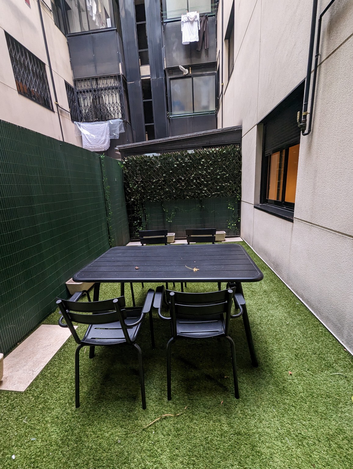 a table and chairs in a courtyard