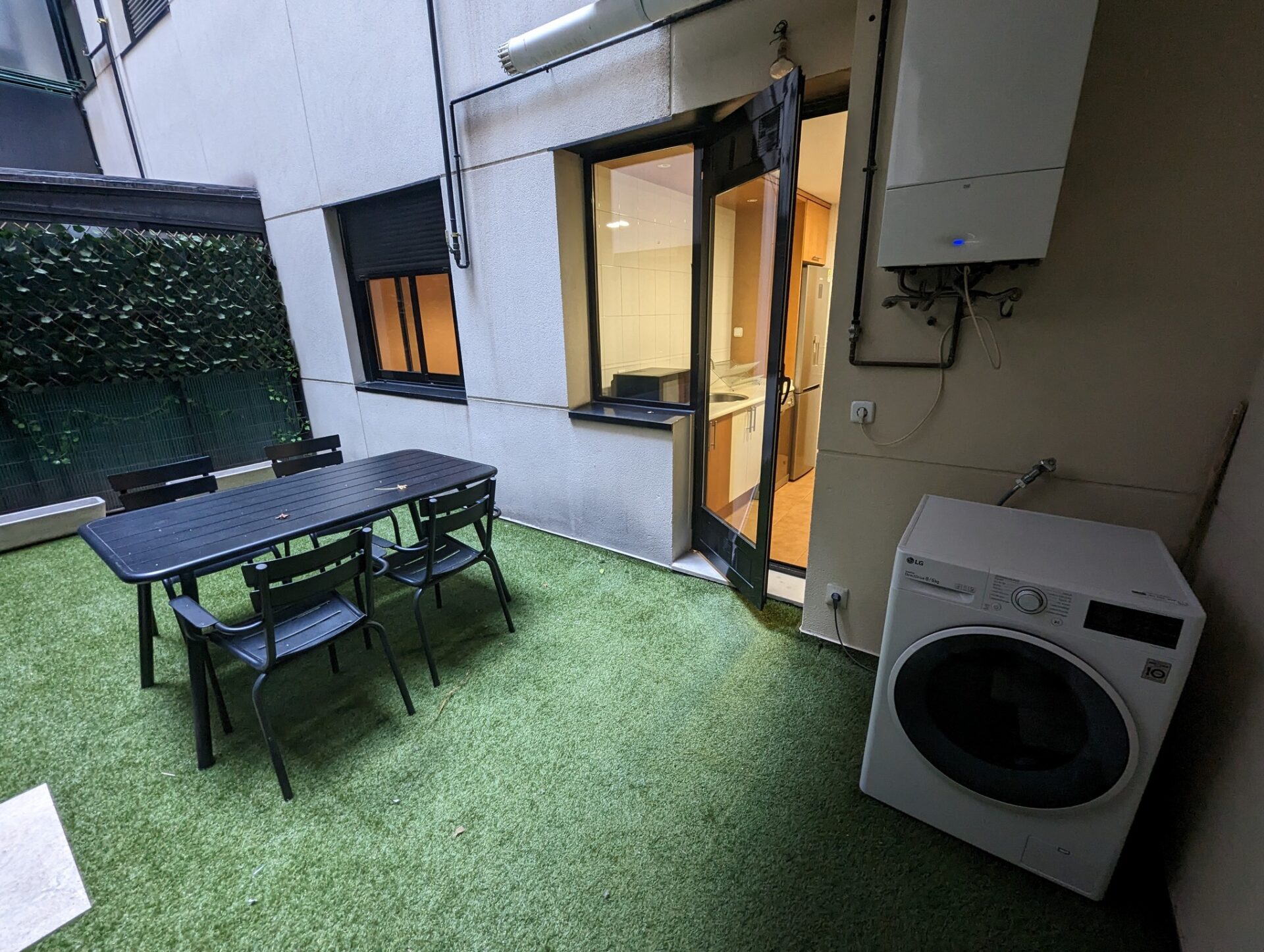 a table and chairs outside of a building