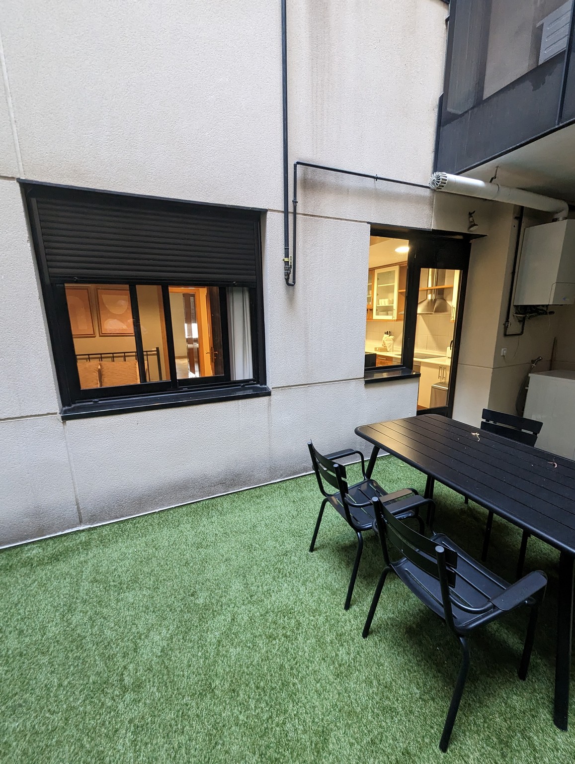 a table and chairs outside of a building