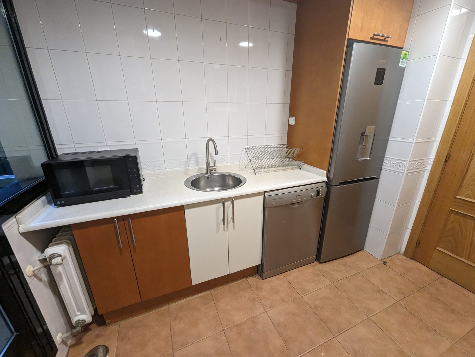 a kitchen with a sink and refrigerator