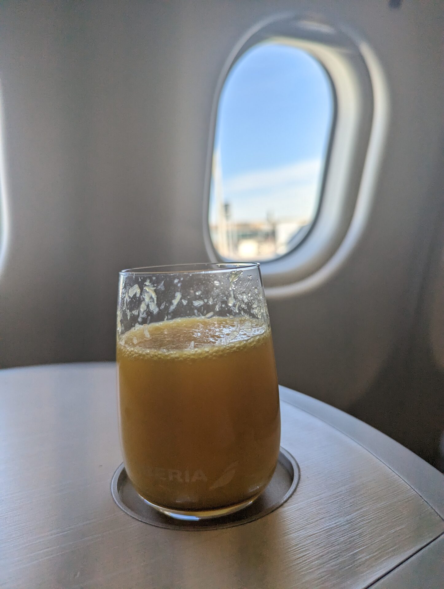 a glass of orange juice on a table