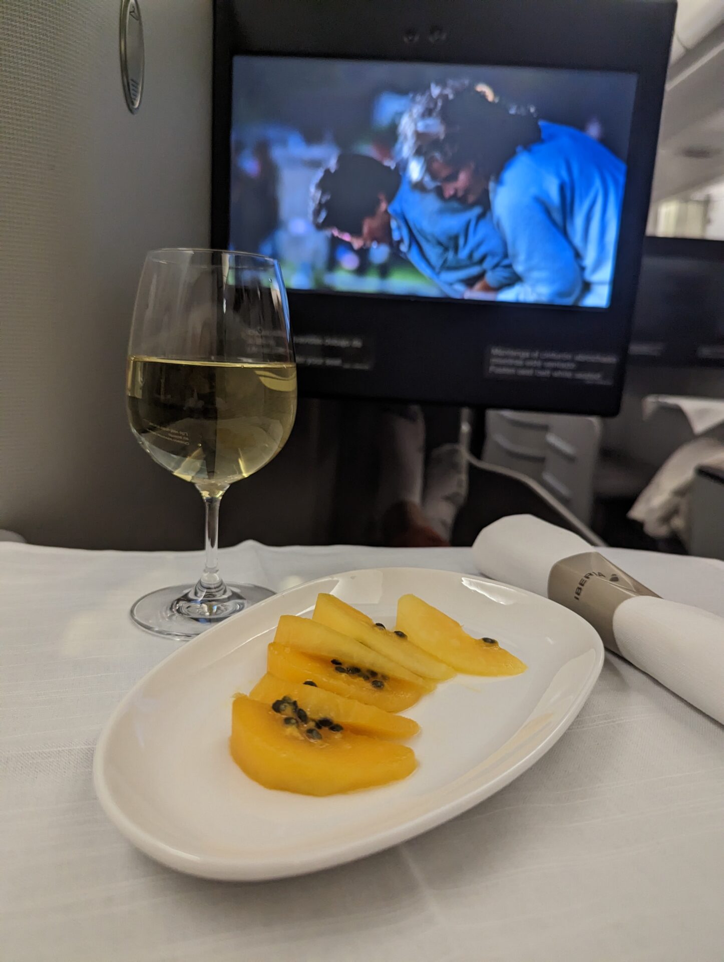 a plate of fruit and a glass of wine