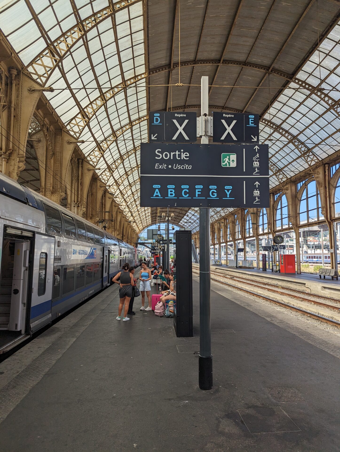 a train station with people waiting